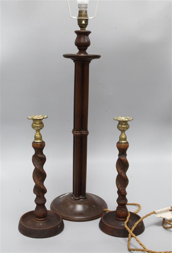 A wooden lamp and a pair of candlesticks